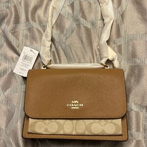 BNWT Never used. COACH signature Klare Crossbody bag. Still in original wrapping